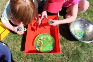 Rescuing the bugs and animals from the jelly with tongs.