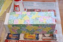 Half-way through covering the box in paper, letting it dry.