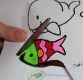 L cutting out her fish.