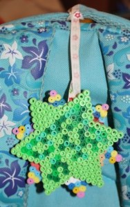 L's new bag tag hanging from the handle of her backpack.