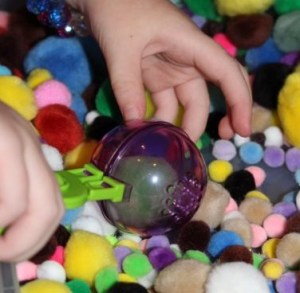 Scooping up some pom poms.