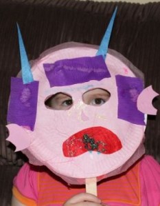 A modelling her monster mask.