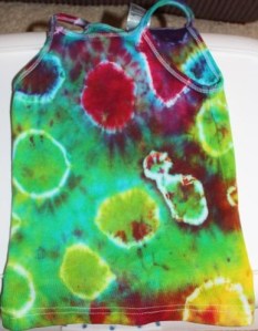 This is A's singlet that had all the little tufts of fabric caught in rubber bands. The whitish circles is where the rubber bands were.