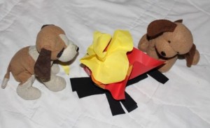 The puppies enjoying the warmth of the campfire.