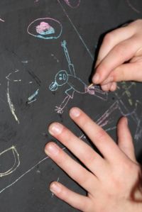 L using a toothpick to scratch out her picture.