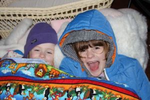 Snuggled in their bed.