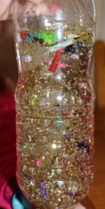 Tipping the bottle upside down.