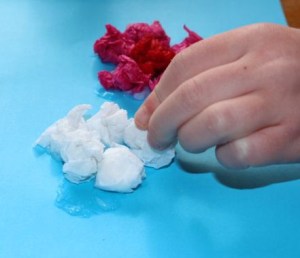 Gluing down the tissue paper balls.