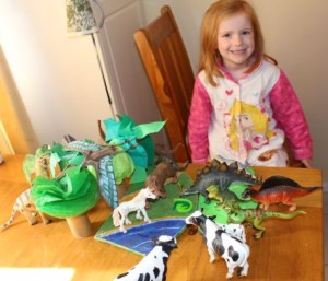 A very happy girl with her new trees and her animals.