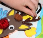 Placing tiny bells on the reindeer's antlers.