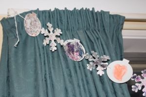 Hanging from the curtain rod.