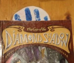 A hand-print bookmark in my latest read.