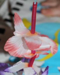 Threading flowers and straws.